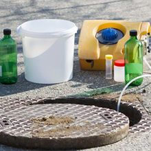 An automated sampler that is collecting a sample from a sewer line.