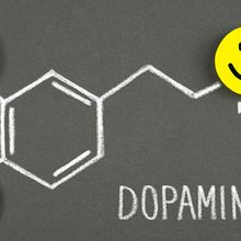 A drawing of a dopamine molecule with happy faces.