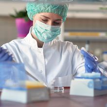 Laboratory technician working at a laboratory bench.