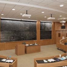 Empty lecture hall with a chalkboard behind the teacher desk.&nbsp;