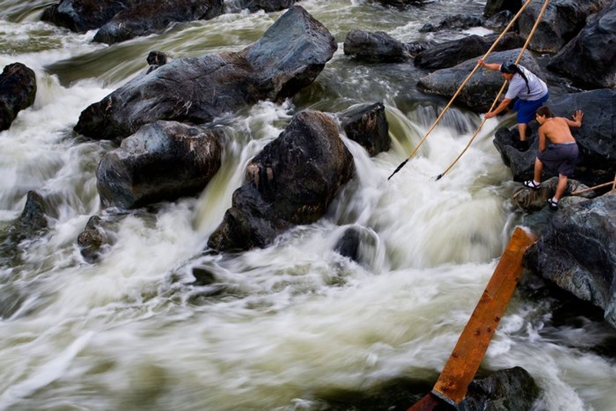 Photo of Ron Reed fishing for salmon at Ishi Pishi Falls with a dip net