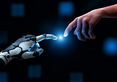 A robot hand makes contact with a human finger on a dark blue background.