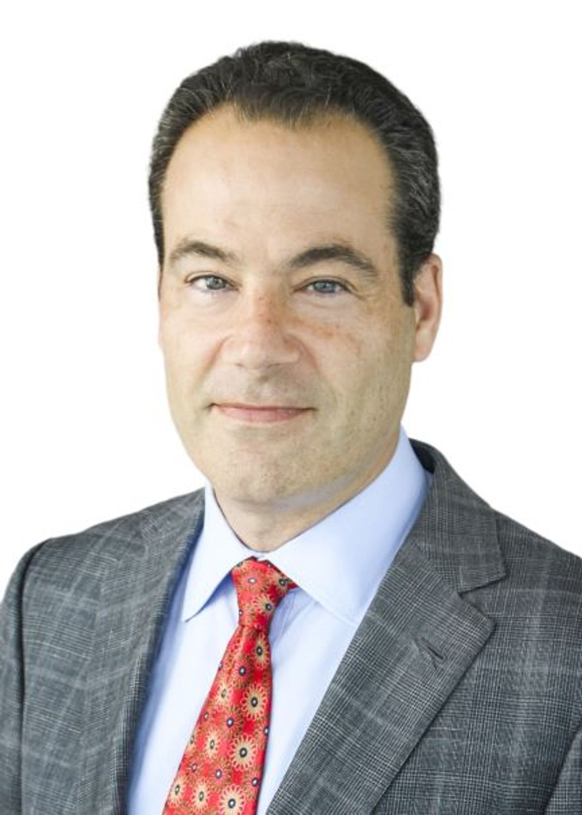 Headshot of Jason Spector, a plastic surgeon at Weill Cornell Medicine. He wears a white shirt, grey jacket, and red tie.