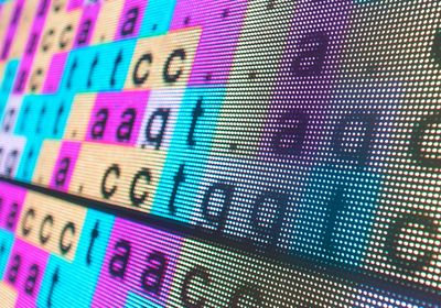 A tilted LED screen showing color-coded DNA sequences.