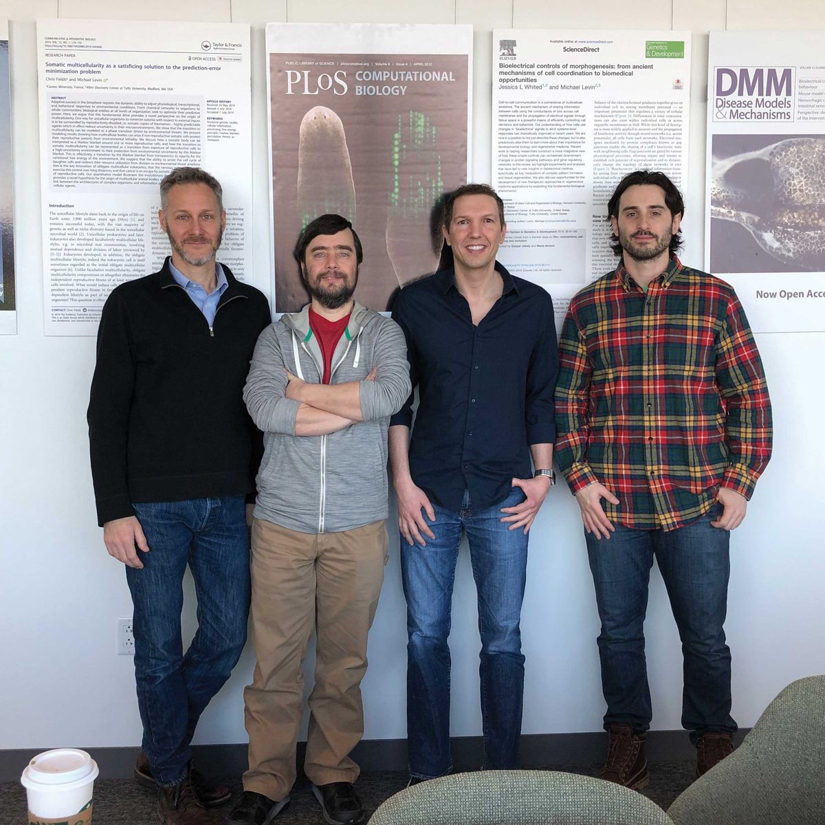 Group photo of four men standing side by side.